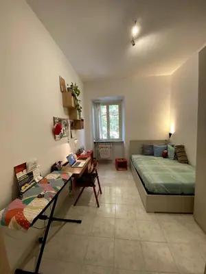 a room with a bed and a desk and a couch at Small and very small house in Rome