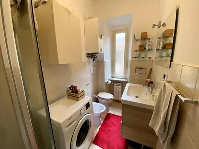 a bathroom with a washing machine and a sink at Small and very small house in Rome