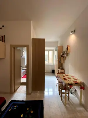 a living room with a table and a dining room at Small and very small house in Rome