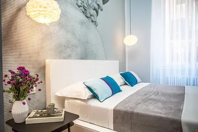 a bedroom with a bed and a table with flowers at Milizie 76 Gallery in Rome