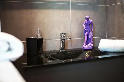 a purple statue sitting on top of a bathroom sink at Milizie 76 Gallery in Rome