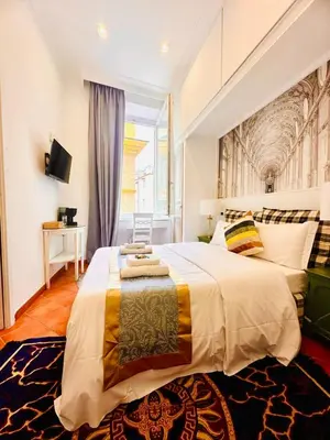 a bedroom with a large bed and a window at Fori Imperiali Colosseum in Rome
