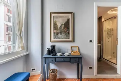 a blue table in a room with a picture on the wall at Fori Imperiali Colosseum in Rome