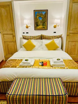a hotel room with a bed with two towels on it at Fori Imperiali Colosseum in Rome