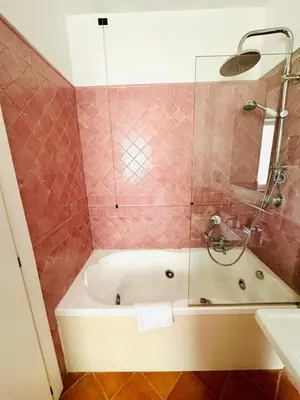 a bathroom with a bath tub with a shower and a sink at Fori Imperiali Colosseum in Rome