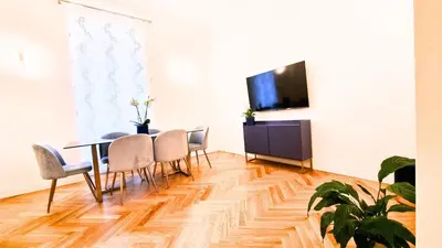 a dining room with a table and chairs and a tv at Beautiful Apartment San Pietro in Rome