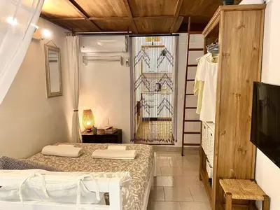 a room with two beds and a window at Trastevere Loft Leopardo in Rome