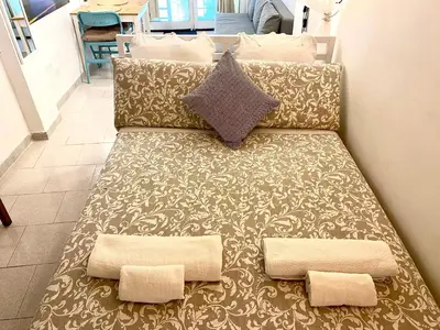 a couch with two pillows on top of it at Trastevere Loft Leopardo in Rome
