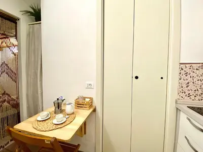 a small table in a kitchen with a cupboard at Trastevere Loft Leopardo in Rome