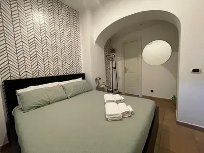a bedroom with a bed with towels on it at Casa Amicitia Piazza di Spagna in Rome