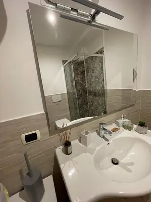 a bathroom with a white sink and a mirror at Casa Amicitia Piazza di Spagna in Rome