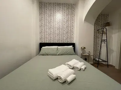 a bedroom with a bed with towels on it at Casa Amicitia Piazza di Spagna in Rome