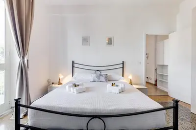 a bedroom with a large white bed with two pillows at L'oasi romana di Daniela in Rome