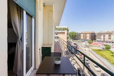 a balcony with a table and a view of a city at L'oasi romana di Daniela in Rome