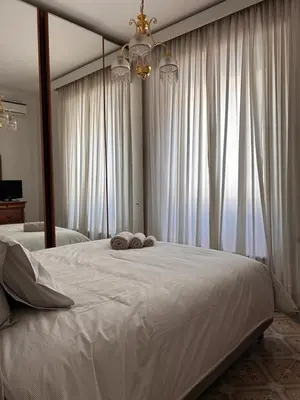a bedroom with a large bed with two towels on it at A casa di Tony in Rome
