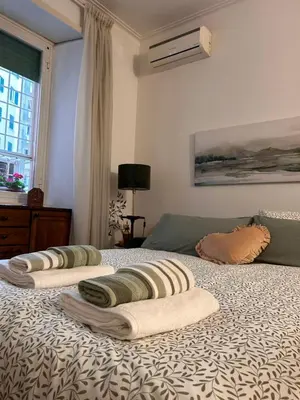a bed with three towels on top of it at A casa di Tony in Rome