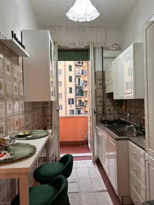 a kitchen with white cabinets and a sink and a window at A casa di Tony in Rome