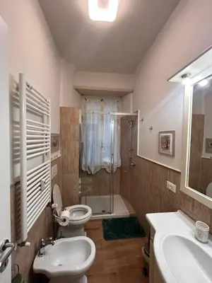 a bathroom with a toilet and a sink and a shower at A casa di Tony in Rome