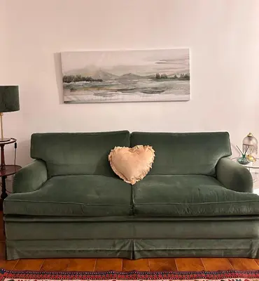 a green couch sitting in a living room at A casa di Tony in Rome