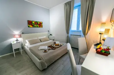 a bedroom with a bed and a table with food on it at Bella Roma Luxury Accommodation, Vatican City - Liberty Collection in Rome