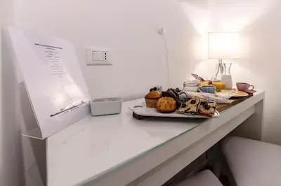 a table with a plate of food on it at Bella Roma Luxury Accommodation, Vatican City - Liberty Collection in Rome