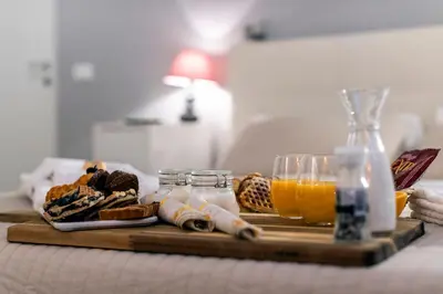 a table with a tray of bread and orange juice at Bella Roma Luxury Accommodation, Vatican City - Liberty Collection in Rome