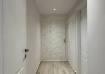 a hallway with a shower with white walls and wooden floors at Casa Colli in Rome