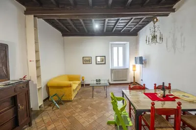 a living room with a table and a yellow couch at Trastevere Charming Apartment in Rome
