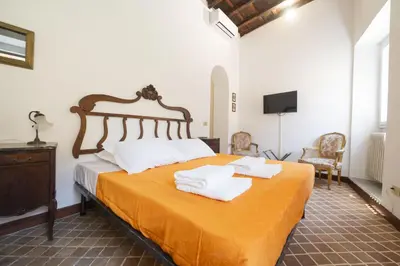 a bedroom with a bed with towels on it at Trastevere Charming Apartment in Rome