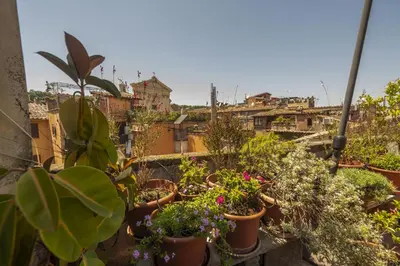 a bunch of potted plants on a balcony at Trastevere Charming Apartment in Rome
