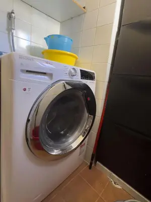 a washing machine with a bucket on top of it at Trastevere Charming Apartment in Rome