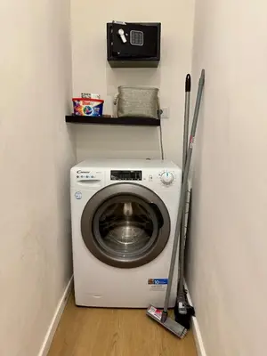 a washer and dryer in a corner of a room at Scala 36, Trastevere, Rome in Rome