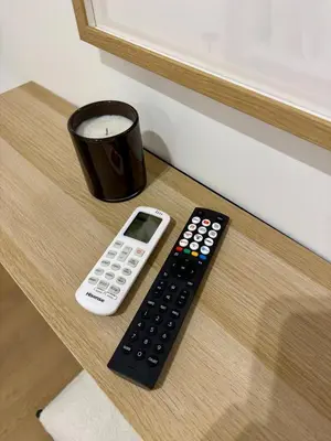 a remote control and a cup on a table at Scala 36, Trastevere, Rome in Rome
