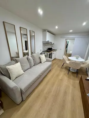 a living room with a gray couch and a table at Scala 36, Trastevere, Rome in Rome