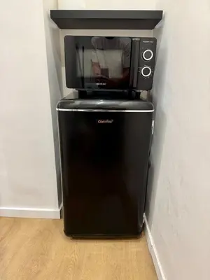 a microwave sitting on top of a refrigerator at Scala 36, Trastevere, Rome in Rome