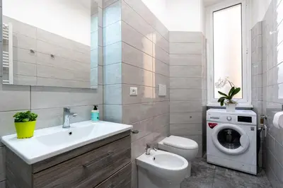 a bathroom with a sink and a washing machine at Imperial House - 300m to Metro B, Open view, 4-6pax in Rome