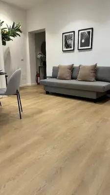 a living room with a couch and a wooden floor at Scala 37 interno 1, Trastevere, Rome in Rome