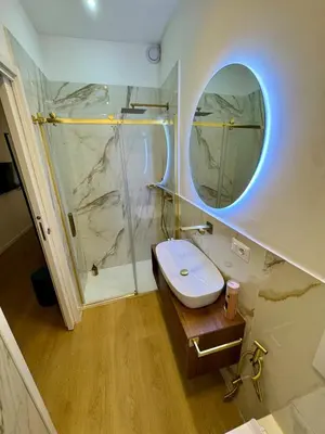 a bathroom with a toilet and a shower with a mirror at Scala 37 interno 1, Trastevere, Rome in Rome