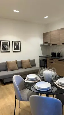 a living room with a couch and a table and chairs at Scala 37 interno 1, Trastevere, Rome in Rome