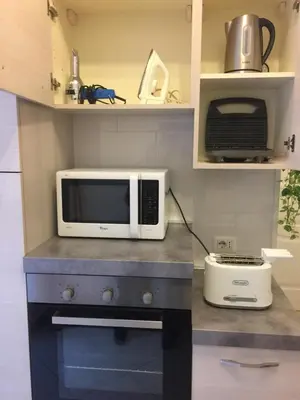 a microwave sitting on top of a counter in a kitchen at Apartment in the center of Rome with spectacular view of the Dome in Rome