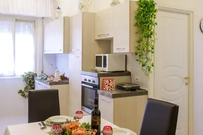 a kitchen with a table and chairs and a microwave at Apartment in the center of Rome with spectacular view of the Dome in Rome