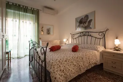 a bedroom with a bed with red pillows on it at Apartment in the center of Rome with spectacular view of the Dome in Rome