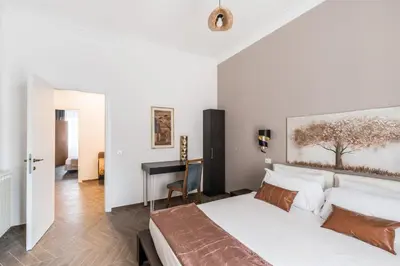 a white bedroom with a bed and a desk at 59 Riverside in Rome