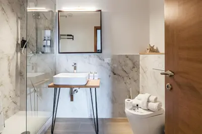 a bathroom with a sink and a toilet and a mirror at 59 Riverside in Rome