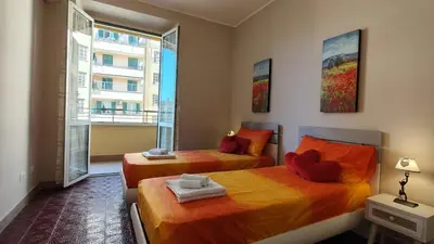 two beds in a room with a window at Metronia Maison in Rome