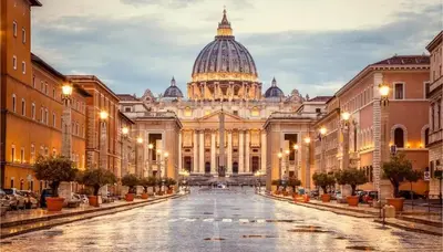 a view of the vatican city at night at Metronia Maison in Rome