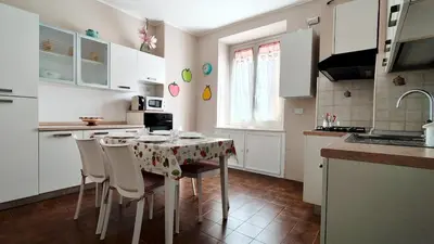 a kitchen with a table and chairs in a kitchen at Metronia Maison in Rome