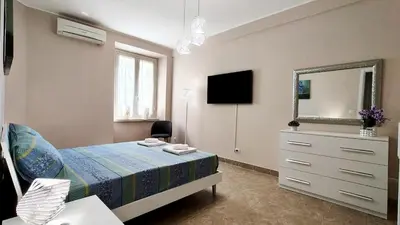 a bedroom with a bed and a dresser and a mirror at Metronia Maison in Rome
