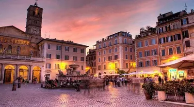 a group of buildings with a clock tower at dusk at Metronia Maison in Rome