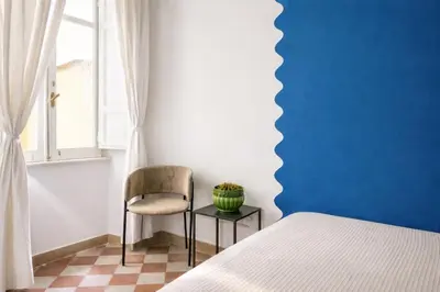 a white living room with a couch and a chair at Incanto al Colosseo - Terrace retreat in Rome